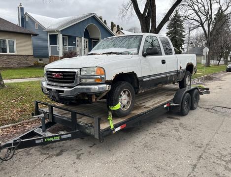 Cash ForCars | GMC Truck on Trailer for Scrap Metal Recycling